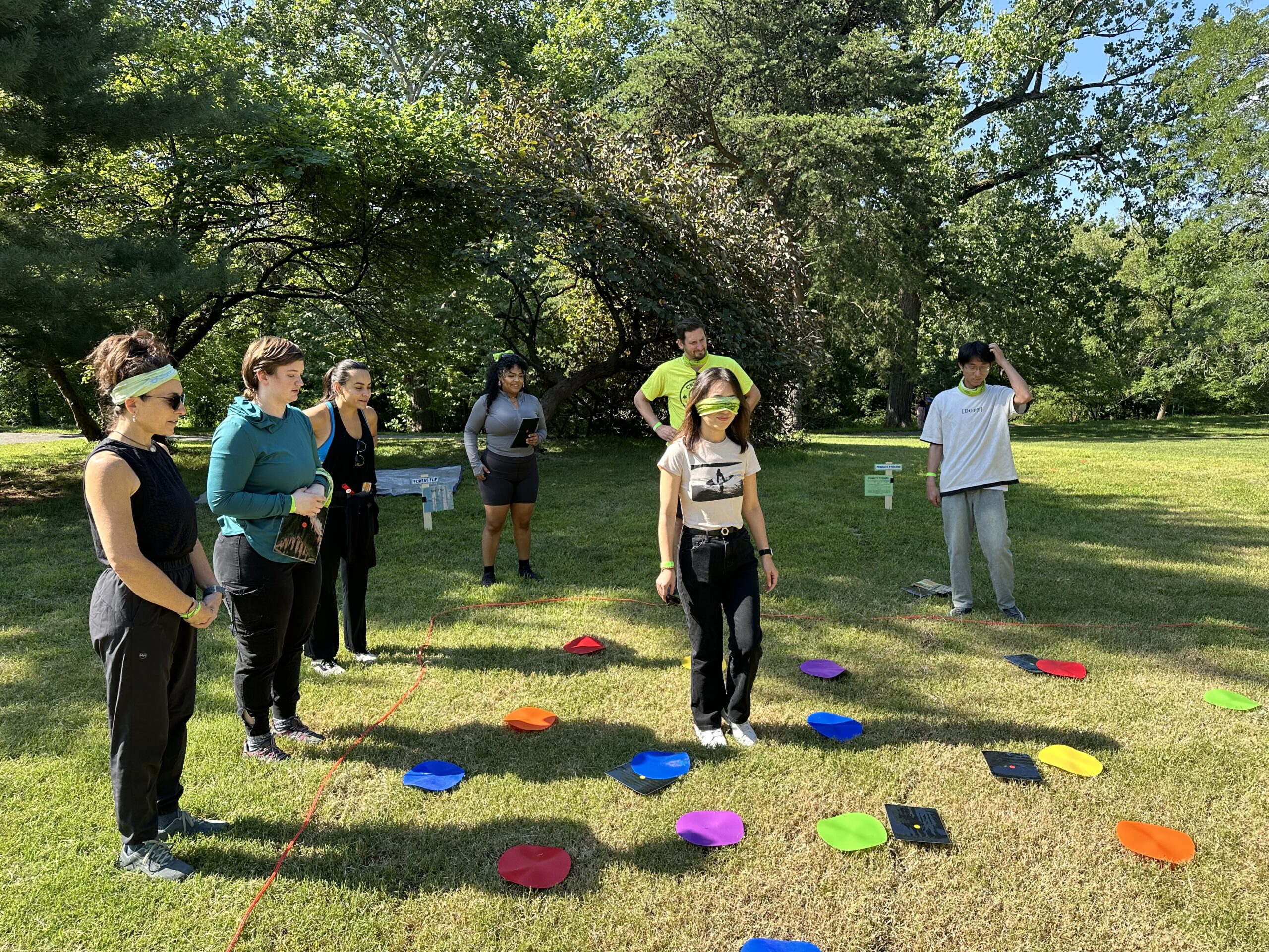 Young adults participating in a blindfolded team building activity