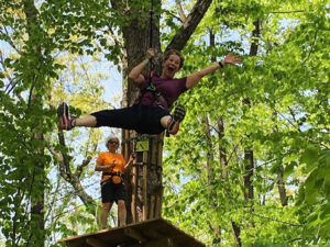 A woman having the time of her life crossing an epic zipline in Springfield, Virginia