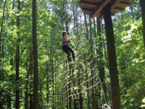 A woman swings into a treetop net on an epic Tarzan swing in Raleigh-Durham, North Carolina