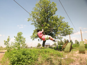 A man coming in for an epic zipline landing in Houston, Texas