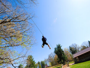 A man flying down a zipline in Rockville, Maryland