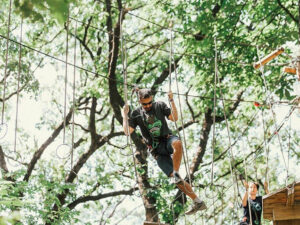 A man tackling an epic treetop obstacle in Kansas City, Missouri