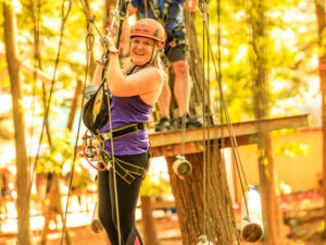A woman crossing a treetop bridge in Ocean City, Maryland