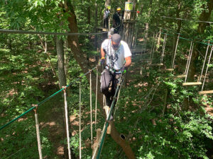 A person tackling an epic treetop bridge in Raleigh-Durham, North Carolina